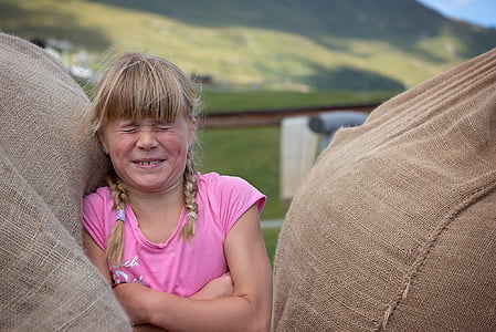 girl standing in between sacks thumbnail