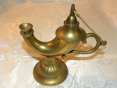 brass-colored footed oil lamp on white fabric textile thumbnail