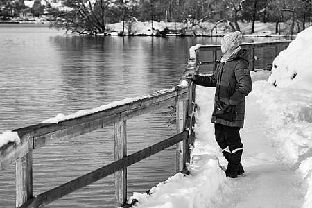 gryscle photography of person standing near body of water thumbnail