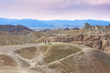 four people in hill during daytime thumbnail