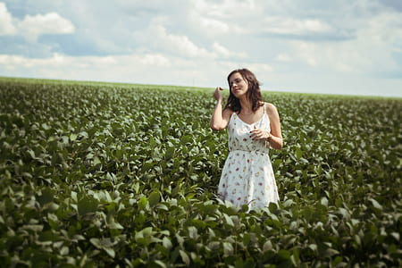 woman standing on plant field thumbnail