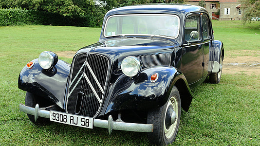 classic black vehicle on green grass field at daytime thumbnail