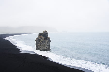 grey rock formation on shoreline at daytime thumbnail