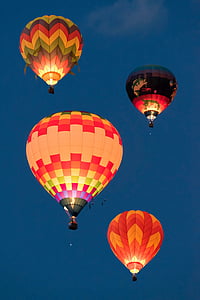 four multicolored hot air balloons flying through sky thumbnail