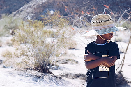 boy crossing his both arms while standing on desert thumbnail