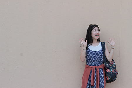 Woman Standing in Front of Brown Wall thumbnail