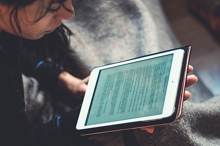 Person reading on iPad tablet thumbnail