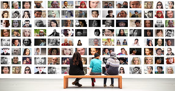 three person sitting on brown wooden bench thumbnail