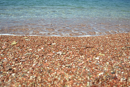 brown pebbles on seashore nearby sea thumbnail