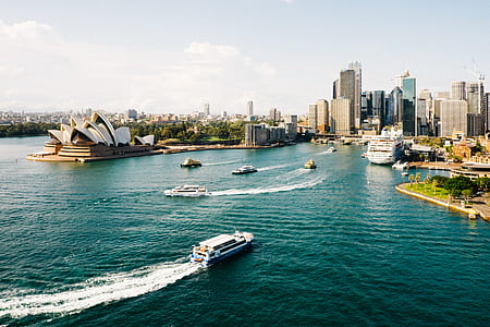 white cruiser boats near Sydney Opera House during daytime thumbnail