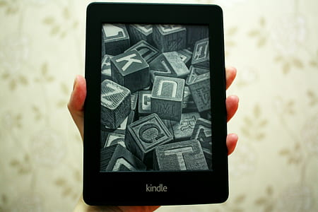 person holding black Kindle E-boor reader thumbnail