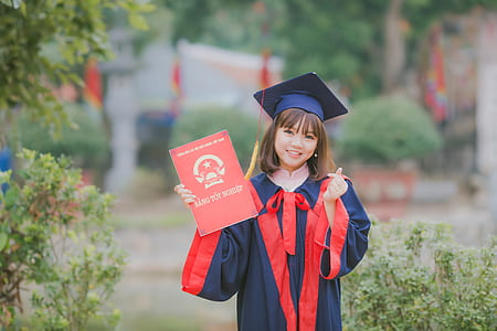 woman holding red certificate thumbnail