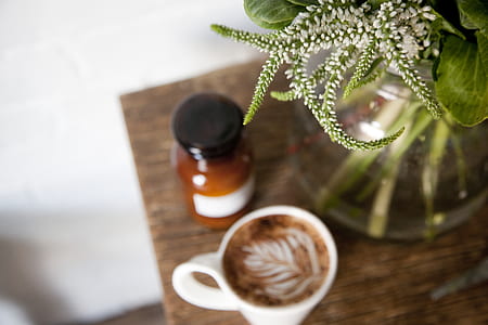 white ceramic mug on brown wooden table thumbnail