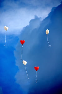 two red and three white heart balloons in the sky thumbnail