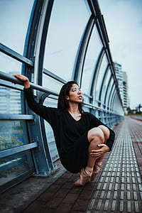 woman sitting beside the railings thumbnail