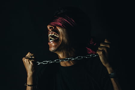 man with blindfold and chain on his neck portrait photo thumbnail