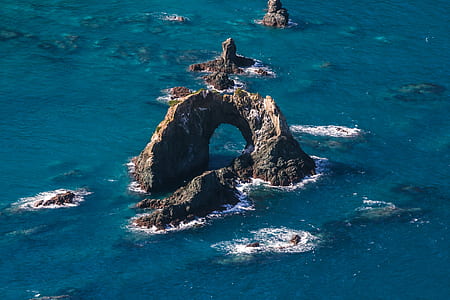 Coastal Rock in body of water during daytime thumbnail