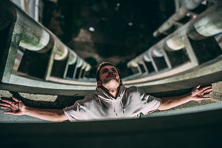 man laying at the edge of a tall building thumbnail