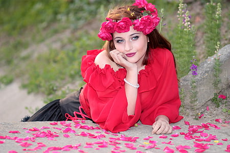 woman wearing red one-shoulder shirt with red rose artificial headdress thumbnail