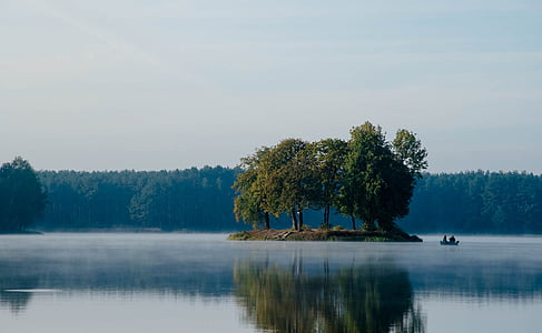 green leafed trees on islet surrounded by water during daytime thumbnail