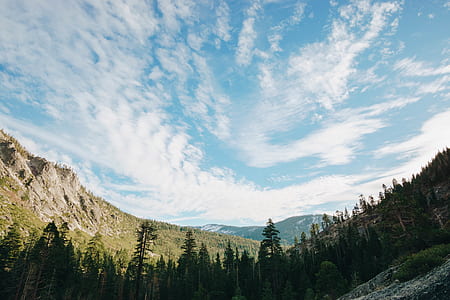 white clouds over green forest mountain photography thumbnail