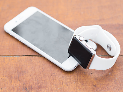 gold aluminum case Apple Watch on top of silver iPhone 6 thumbnail