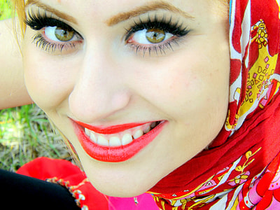 woman wearing red, white, and yellow headscarf close-up photo thumbnail