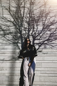 Photography of Woman Leaning On Wall thumbnail