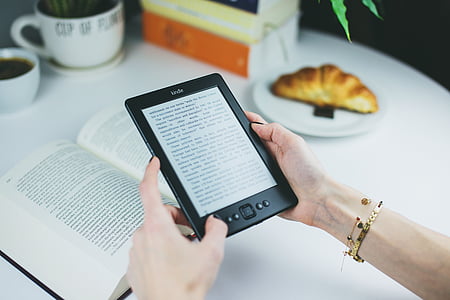 person holding Amazon Kindle e-reader thumbnail