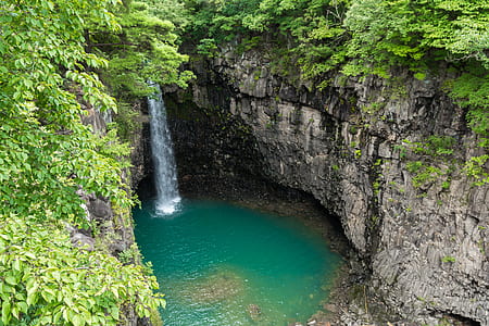 waterfalls and green leafed trees at daytime thumbnail