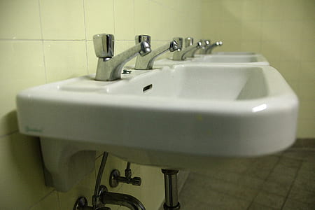 white ceramic sink with faucets on wal thumbnail