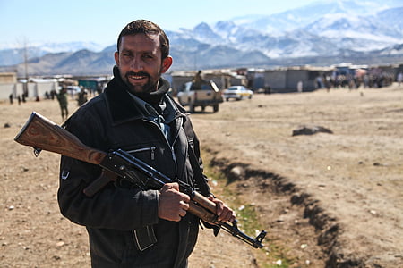 man carrying AK-47 during daytime thumbnail