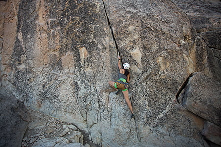 woman climbing on rock formation thumbnail