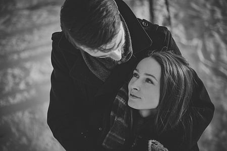 man in black coat hugging woman thumbnail