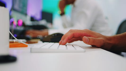 shallow focus photography of persons hand on keyboard thumbnail