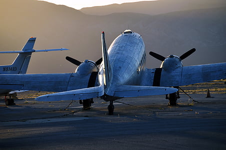 gray airplane and mountains at the distance during day thumbnail
