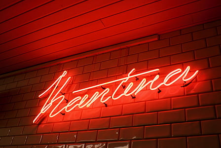 red neon signage mounted on brown concrete wall thumbnail