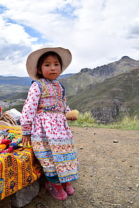 girl wearing traditional dress on hill during day thumbnail