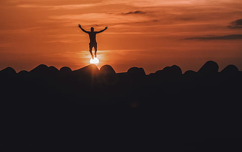 silhouette of man jumping during golden hour thumbnail