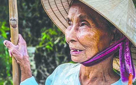 close up photo of woman wearing brown straw hat thumbnail