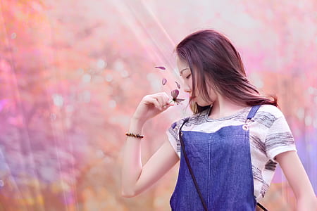 woman with blue denim top and white striped shirt holding grey butterfly thumbnail
