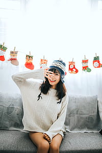 woman sitting on couch raising her right hand near her face thumbnail