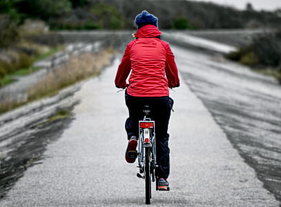shallow focus photography of person cycling on road thumbnail