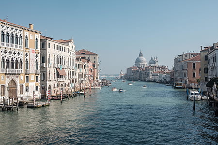 white and beige concrete buildings near body of water thumbnail