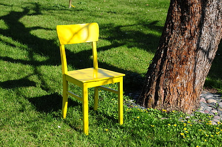 yellow wooden chair on green grass thumbnail