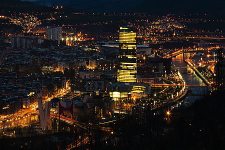 city buildings with lights at nighttime thumbnail