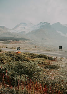road near snow-capped mountain during daytime thumbnail