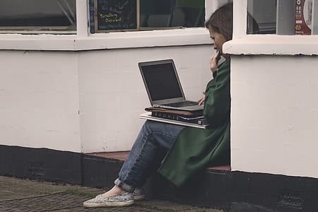 woman sitting with laptop on lap thumbnail