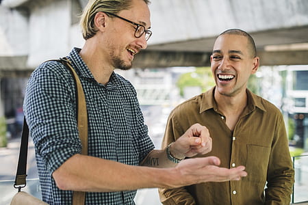 man smiling beside another man thumbnail