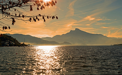 silhouette of mountain near ocean during day time thumbnail